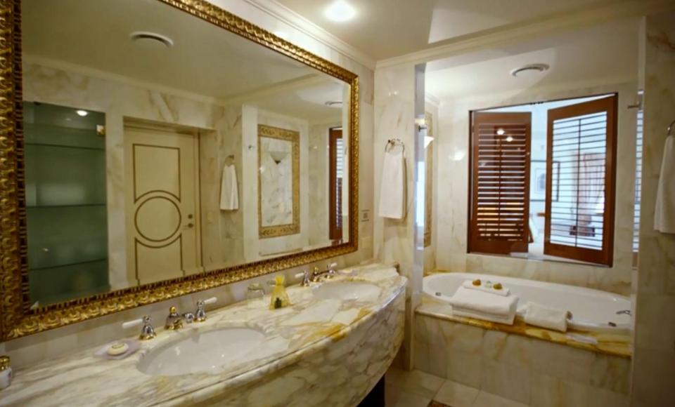  The suite's plush marble bathroom with a whirlpool tub