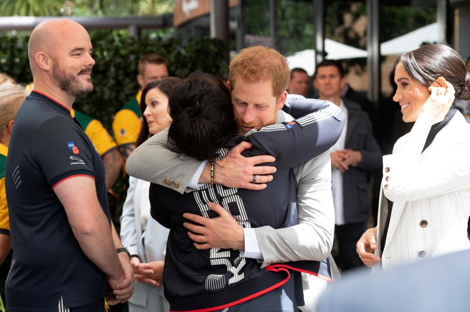  Meghan watches her husband hug UK Team vice captain Michelle Turner at the games