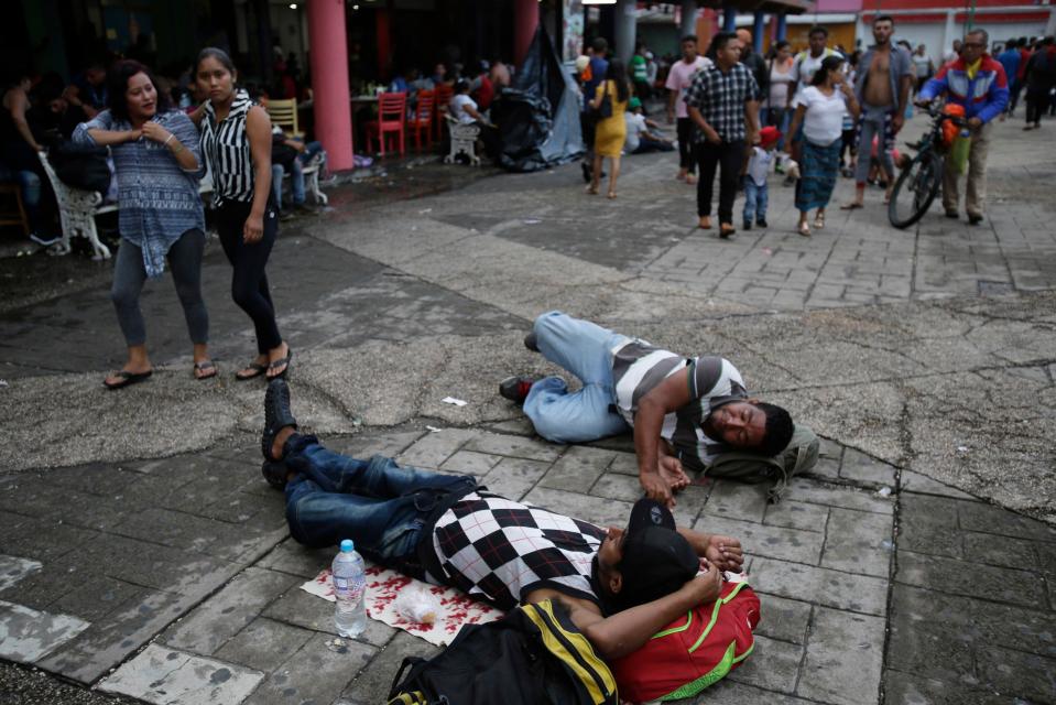  Central American migrants making their way to the US in a large caravan rest lying at the central park in Tapachula