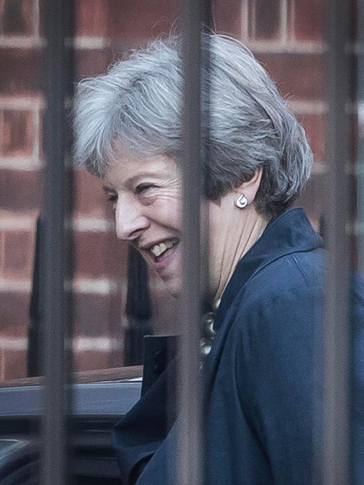  Theresa May smiles as she arrives at Downing Street this morning