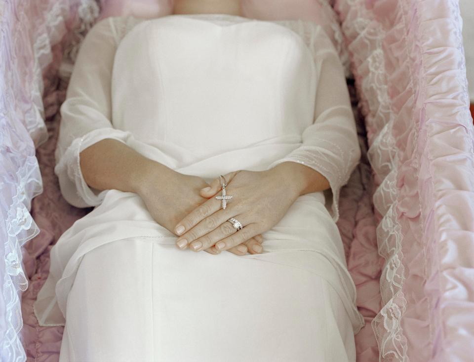  Family bring in clothes for the final farewell and women are often buried in their wedding dresses