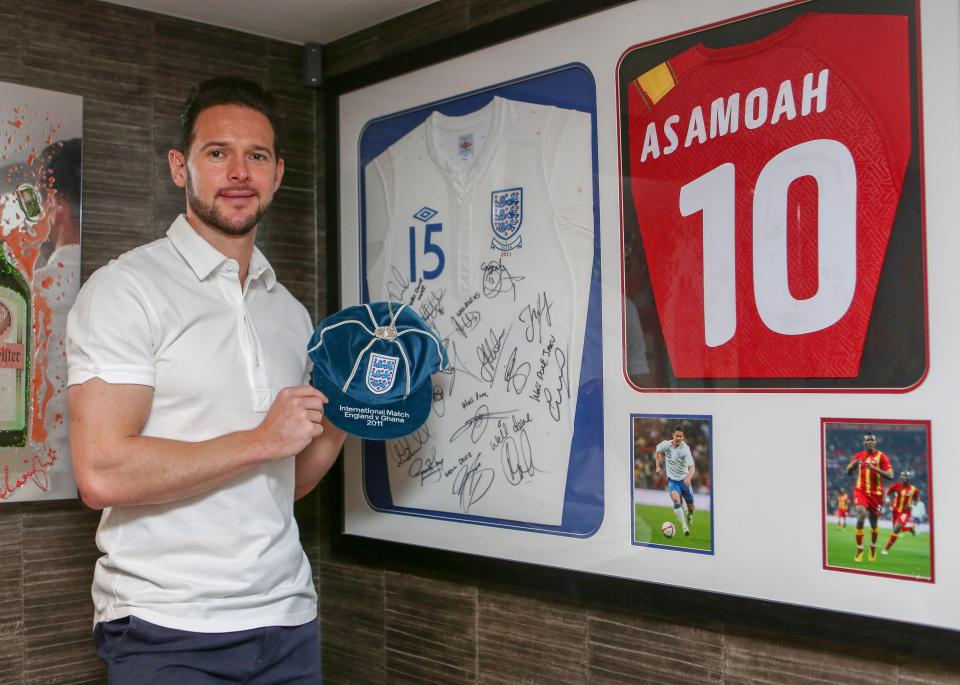  Jarvis with his shirt from the game signed by all the players as well as Asamoah Gyan's match jersey