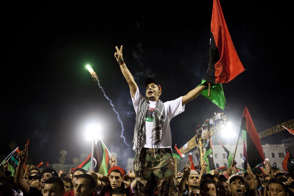  Libyans celebrating the downfall of Gaddafi in central Tripoli