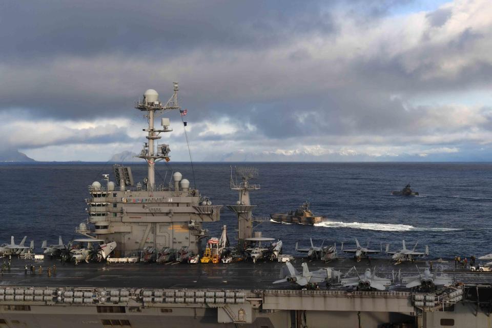  Royal Norwegian Navy Skjold-class Corvettes HNOMS Storm and HNMOS Skudd ride alongside the US Navy aircraft carrier USS Harry S. Truman during flight operations supporting Exercise Trident Juncture