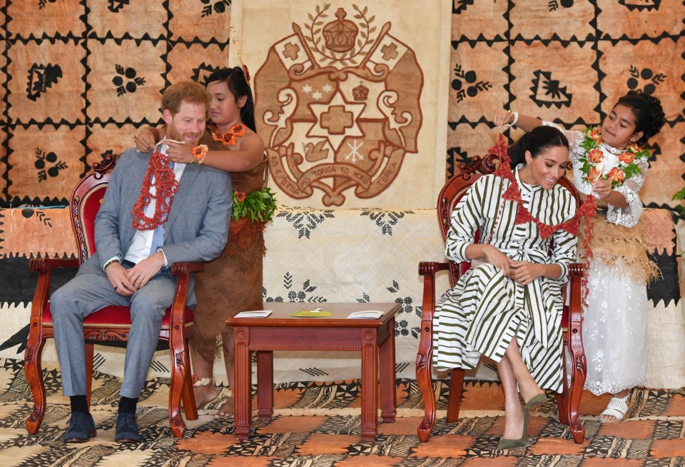 The Duke and Duchess of Sussex are given flower garlands at the Fa’onelua Convention Centre on the second day of the royal couple’s visit to Tonga