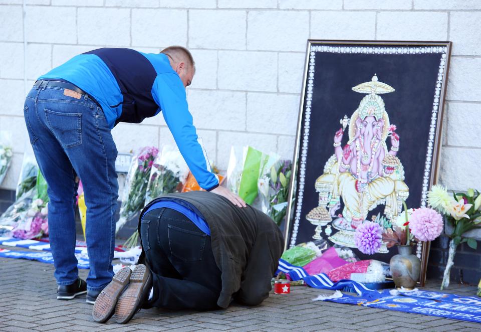  Fans comfort each other at the site of the tragedy that has been turned into a shrine