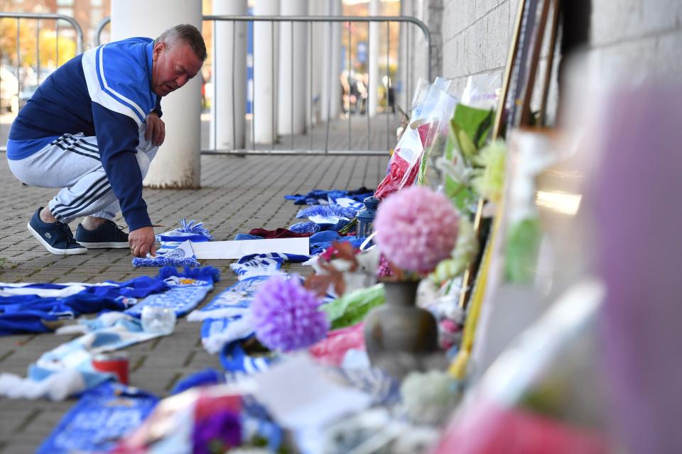  A supporter lays flowers outside the stadium this morning