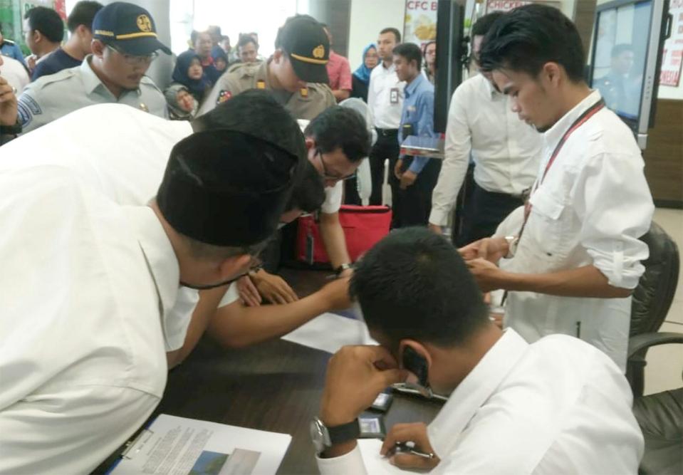  Lion Air officials check the passenger list of Lion Air flight JT610 that crashed into the sea