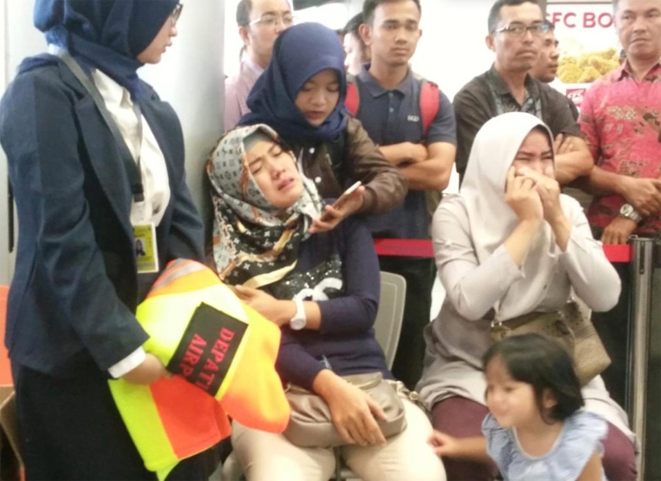 Relatives of passengers of Lion Air flight JT610 that crashed into the sea cry at Depati Amir airport in Pangkal Pinang, Indonesia