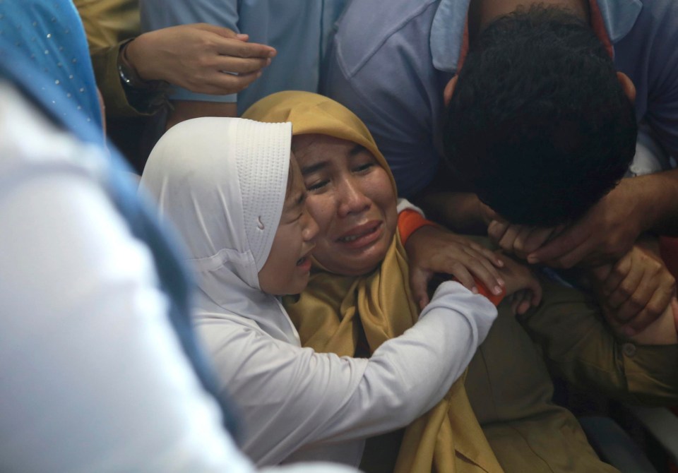 Relatives of passengers comfort each other after hearing news of the Lion Air plane crash this morning