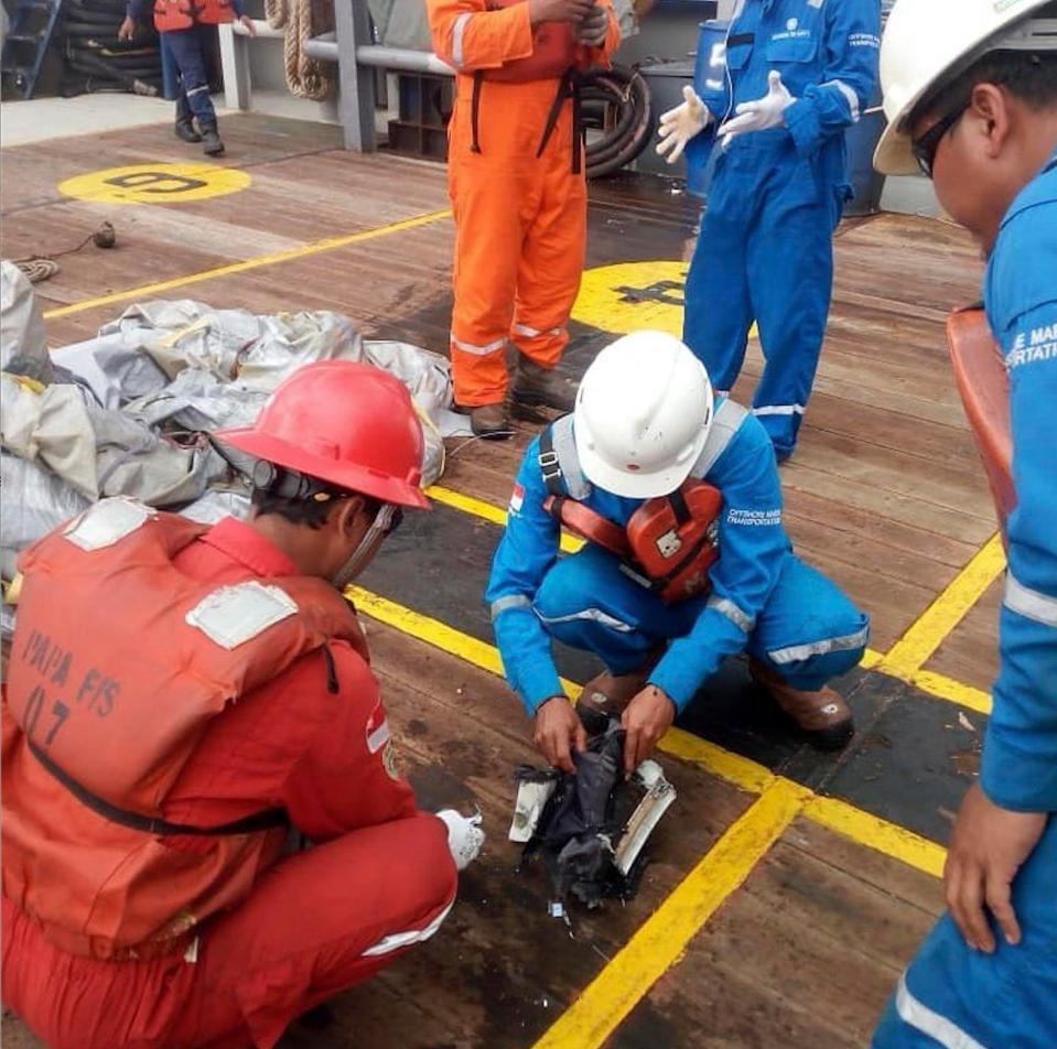  Rescuers inspect debris believed to be from a Lion Air passenger jet that crashed off West Java