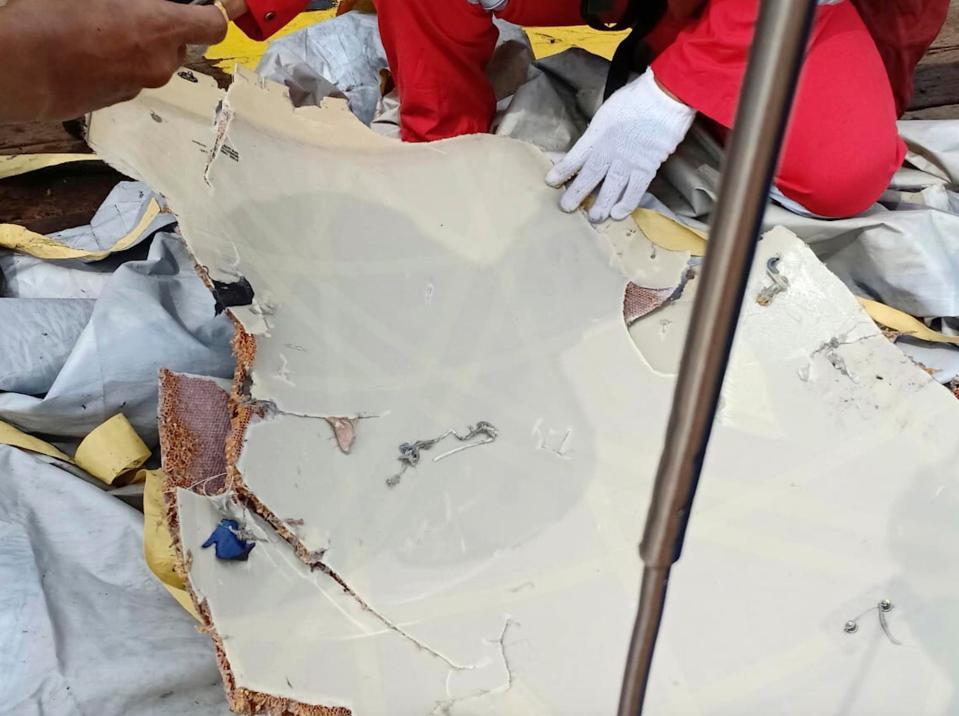  Indonesia's disaster agency posted photos online of a crushed smartphone, books and bags