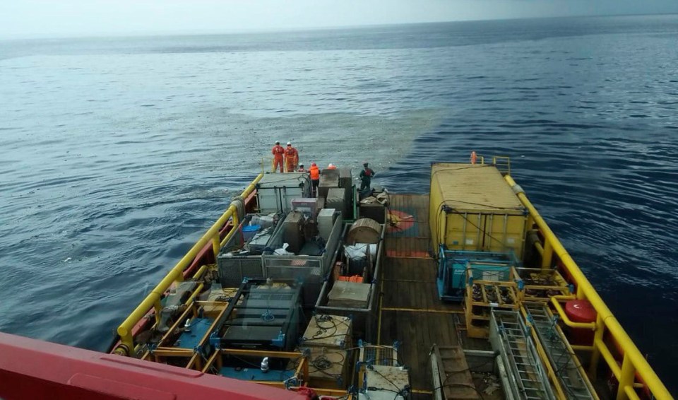 Rescuers inspect an oil slick debris believed to be from Lion Air passenger jet