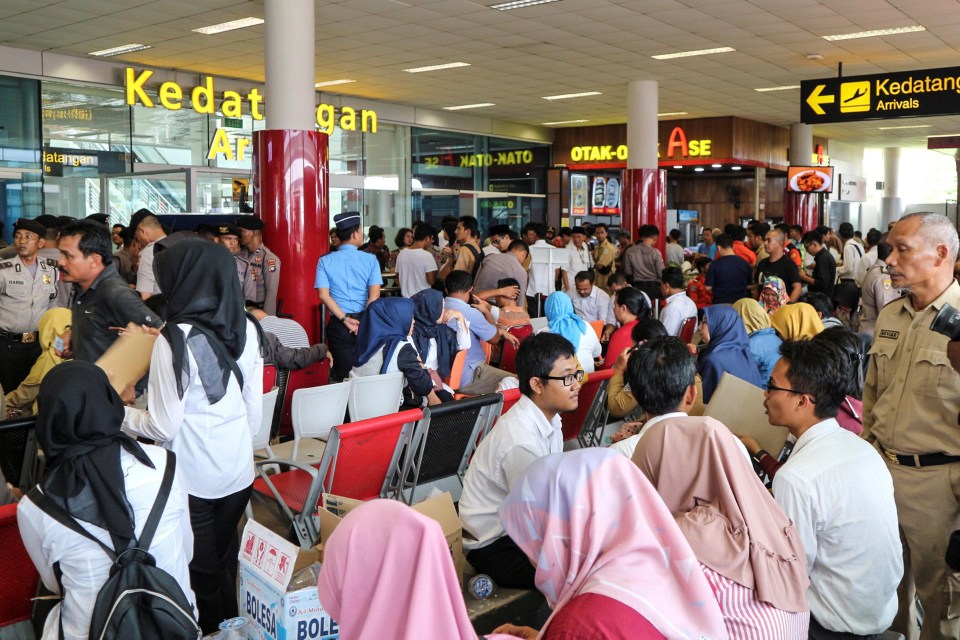 Relatives of passengers of the Lion Air plane that crashed into the sea are seen at Depati Amir airport in Pangkal Pinang