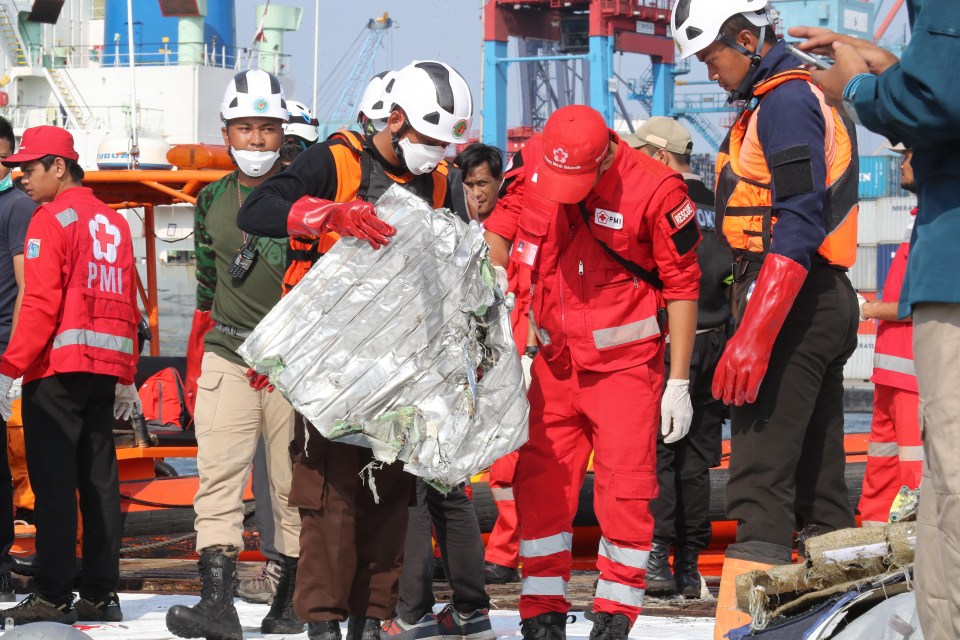 Rescue team members collecting the remains of the crashed plane at Tanjung Priok Harbour