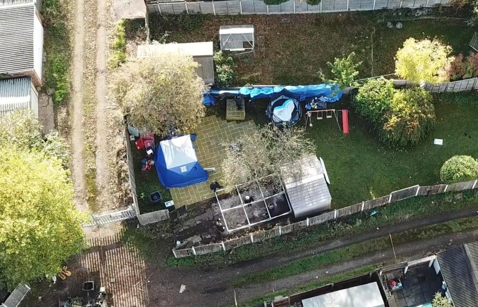  A forensic tent has been erected over an area of concrete patio where the garage stood