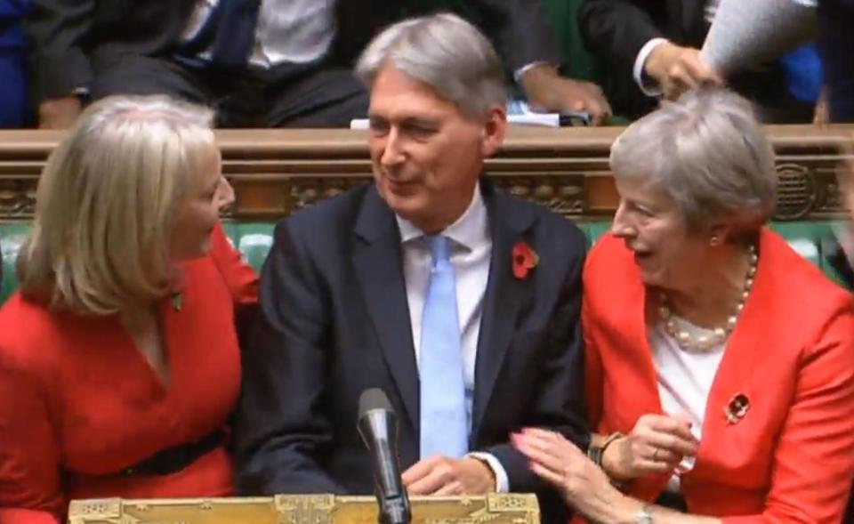  Chief Secretary to the Treasury Liz Truss (left) and Prime Minister Theresa May congratulate Chancellor of the Exchequer Philip Hammond after his Budget statement