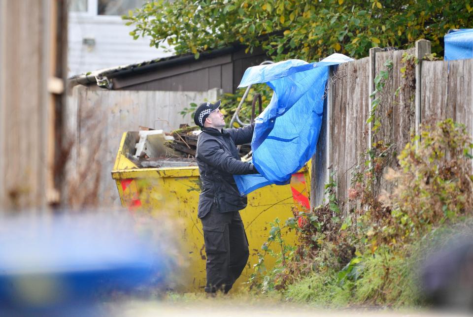  An officer can be seen at the previous home of John Cannan's mother