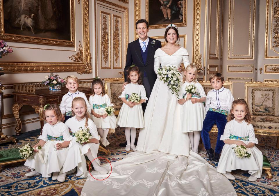  Bridesmaid Savannah Phillips, seven, stood on Princess Eugenie's wedding dress in the official photo