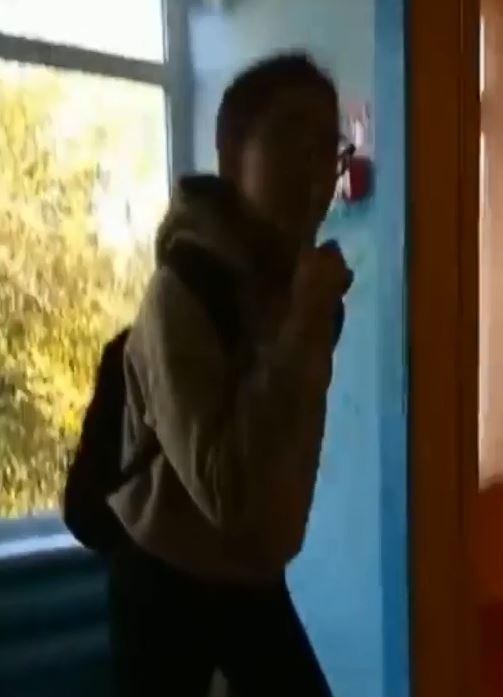 In this still taken from a video a pupil can be seen bringing her finger to her mouth as if to say 'hush'