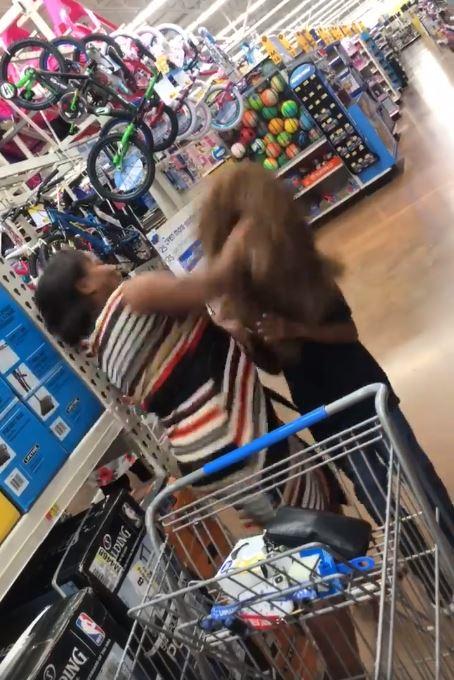  Tashila Alexander gives her son a whack after he took her by surprise