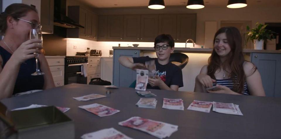  Theo, 12, was delighted with the budget and the family counted it out at their new kitchen table