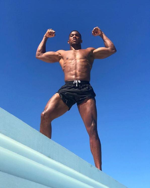 Anthony Joshua looks ripped on holiday in Jamaica as the heavyweight gets ready to jump off a poolside ROOF