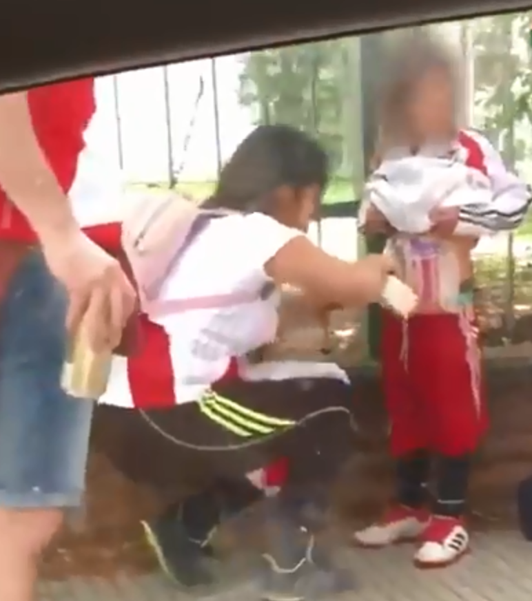 A video showing a woman taping flares to her son has gone viral