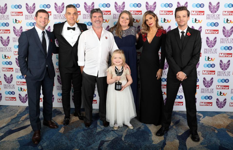  Ella Chadwick, who won the Child of Courage Award, poses with the X Factor judges and host