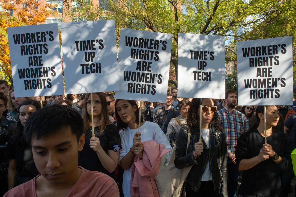  A group of protesters in New York hold placards during the walkout