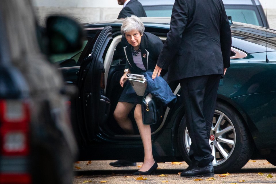 Theresa May pictured arriving at Downing Street this morning