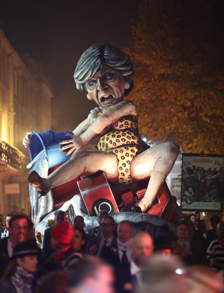  Mrs May is shown bailing out water from 'sinking ship' No10