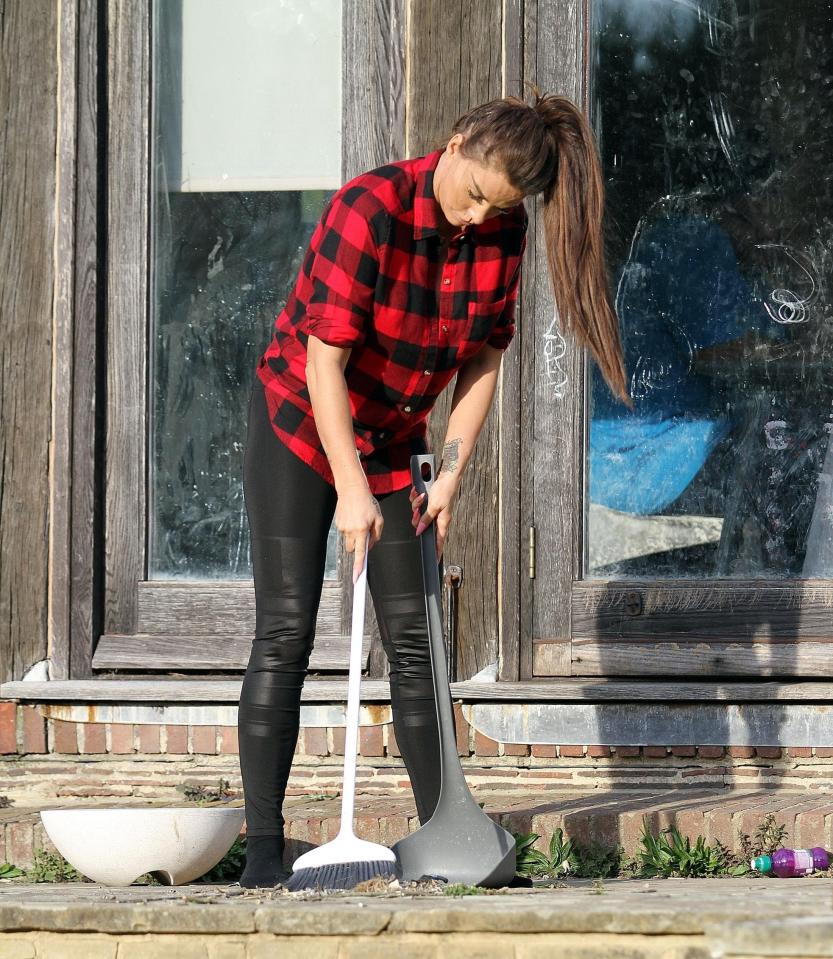 The star seemed hard at work as she cleaned up the rubbish-littered garden with a dustpan and broom