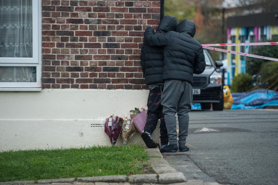  Mourners console each other at the scene of John O's murder on Monday