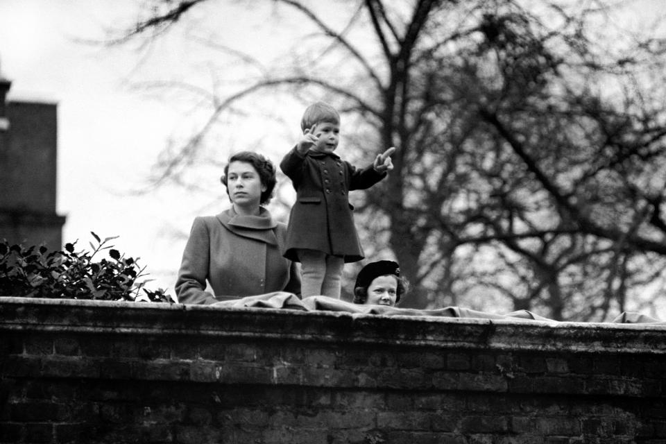  1950: Prince Charles, watching the procession from the wall of Clarence House, as Queen Juliana and Prince Bernhard of the Netherlands drive to the Guildhall