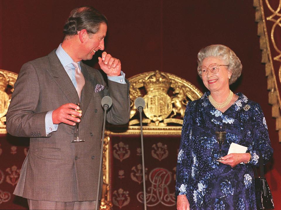  1998: The Prince of Wales smiling at his mother, Queen Elizabeth II, during his speech at a 50th birthday reception in his honour at Buckingham Palace