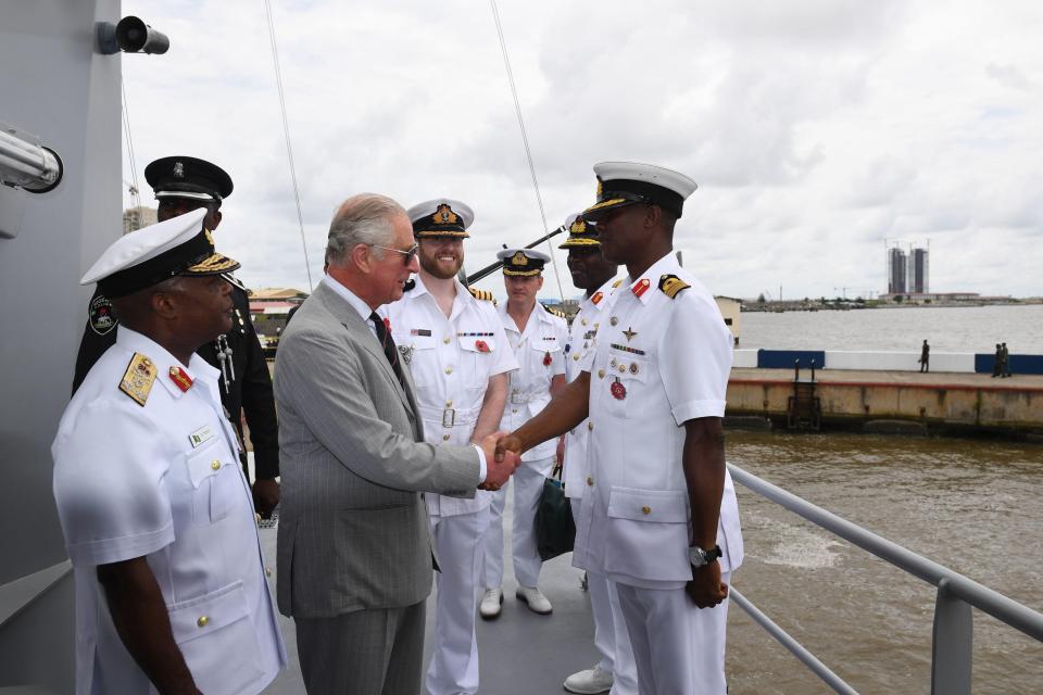  The Prince shakes the hands of crew members on the ship