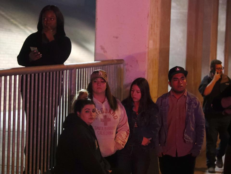  Young people wait near the scene of the shooting awaiting updates from police officials