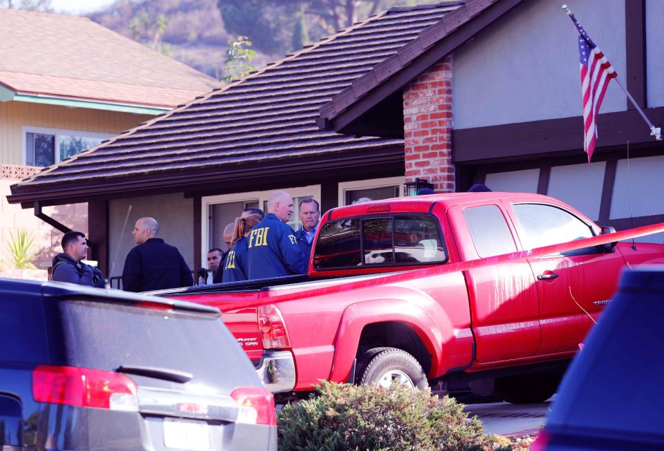 Police and FBI officers wait outside Long's house in Newbury Park which is close to the Thousand Oak Bar