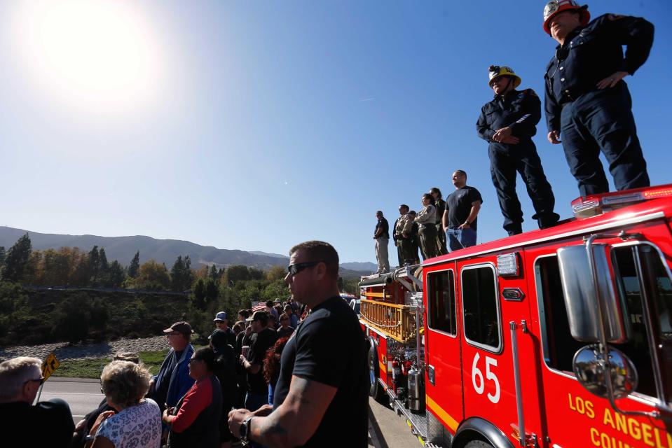  Los Angeles County firefighters and Ventura County Sheriff officers await a procession for the body of Sergeant Ron Helus