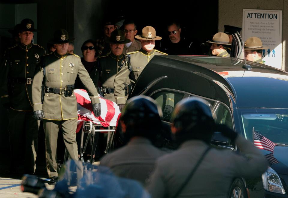  The body of Ventura County Sheriff Sgt Helus is transferred to a hearse