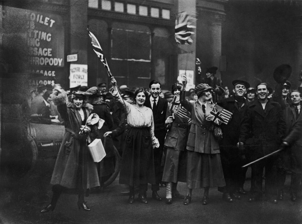 Service men and women and civilians celebrating Armistice Day 1918