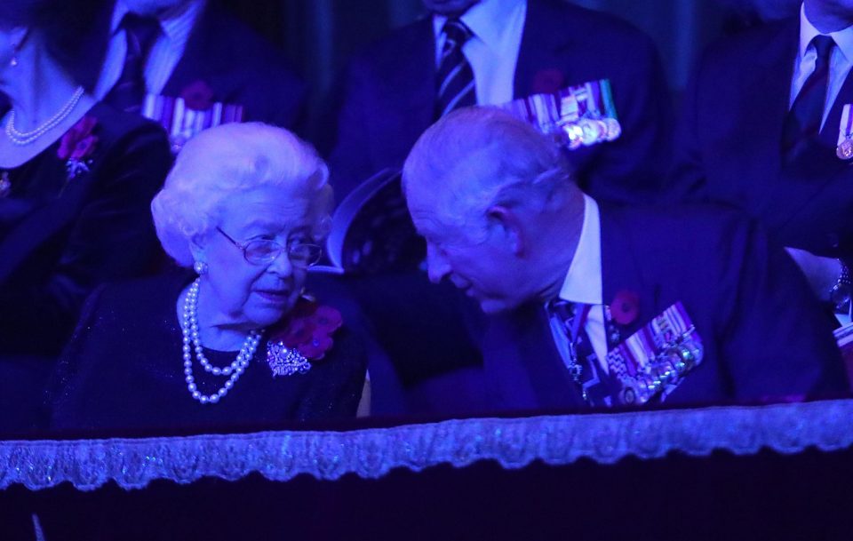  The Queen and Prince Charles share a word as they take their seats