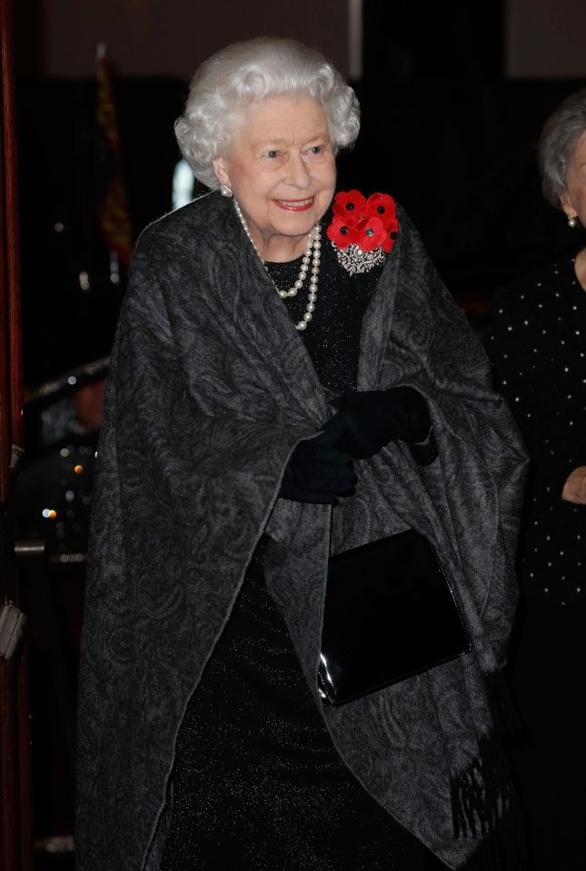  Her Maj smiles as she enters the Royal Albert Hall this evening wearing a poppy broach