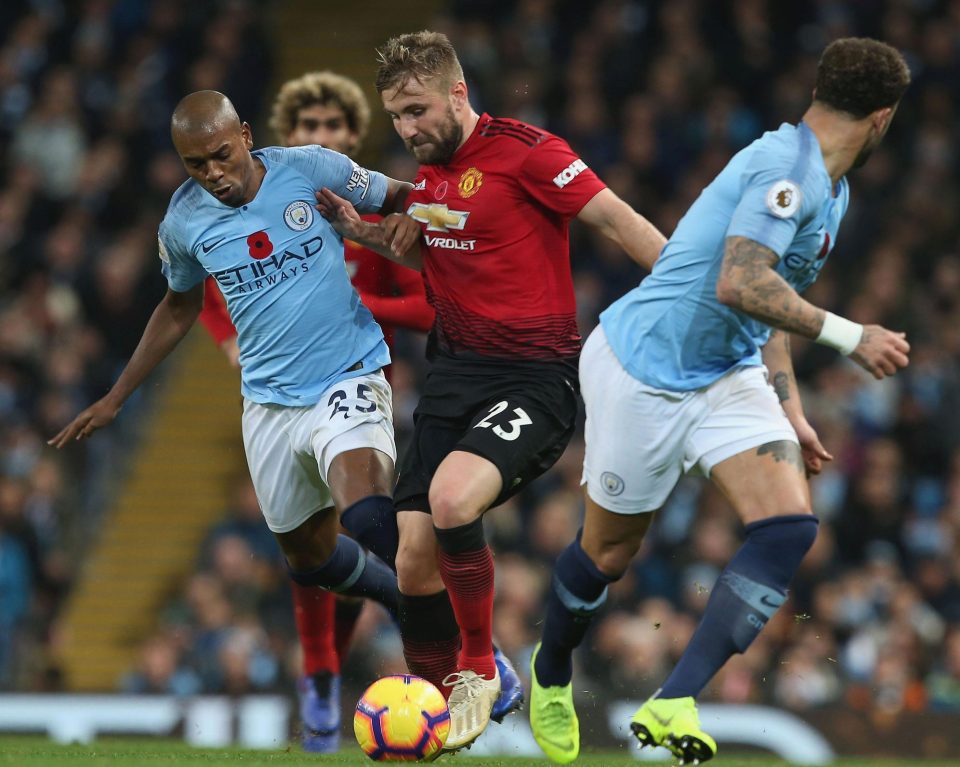  Fernandinho tussles with Luke Shaw for the ball