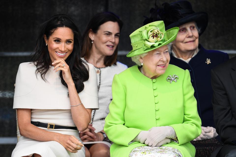 Meghan and The Queen are snapped with Sam Cohen in between them in the background - she is standing in as Private Secretary for the Sussexes