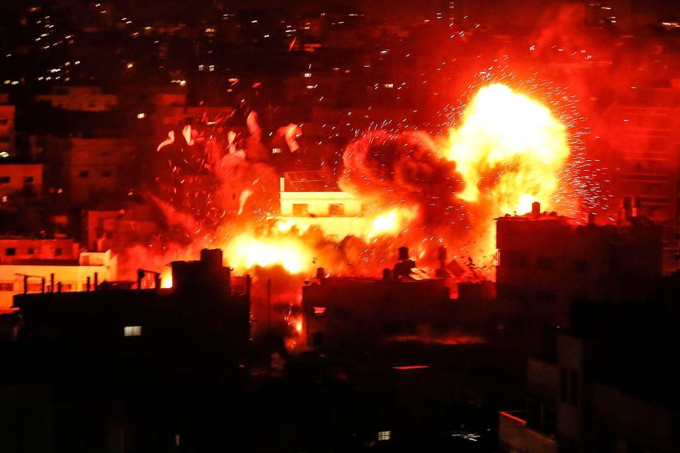  A ball of fire above the building housing the Hamas-run television station al-Aqsa TV in the Gaza Strip during an Israeli air strike