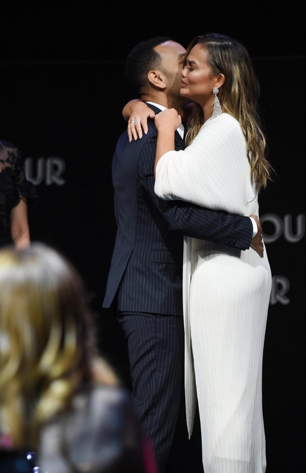  Chrissy hugged her husband on stage after his speech