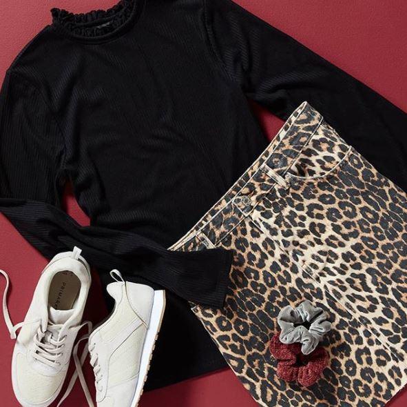  Primark's bargain leopard print skirt looks effortlessly thrown together with a black turtleneck and pair of white trainers