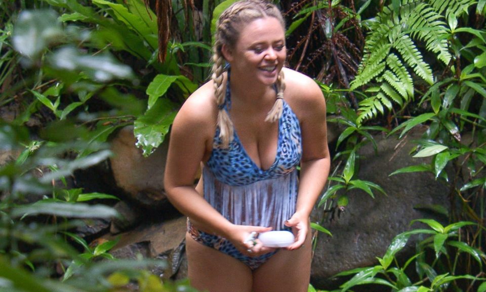 A happy Emily seems at home in the jungle while wearing a revealing blue bikini